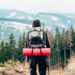 Caucasian male backpacking in mountains