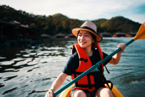 Asian Woman kayaking in a lake